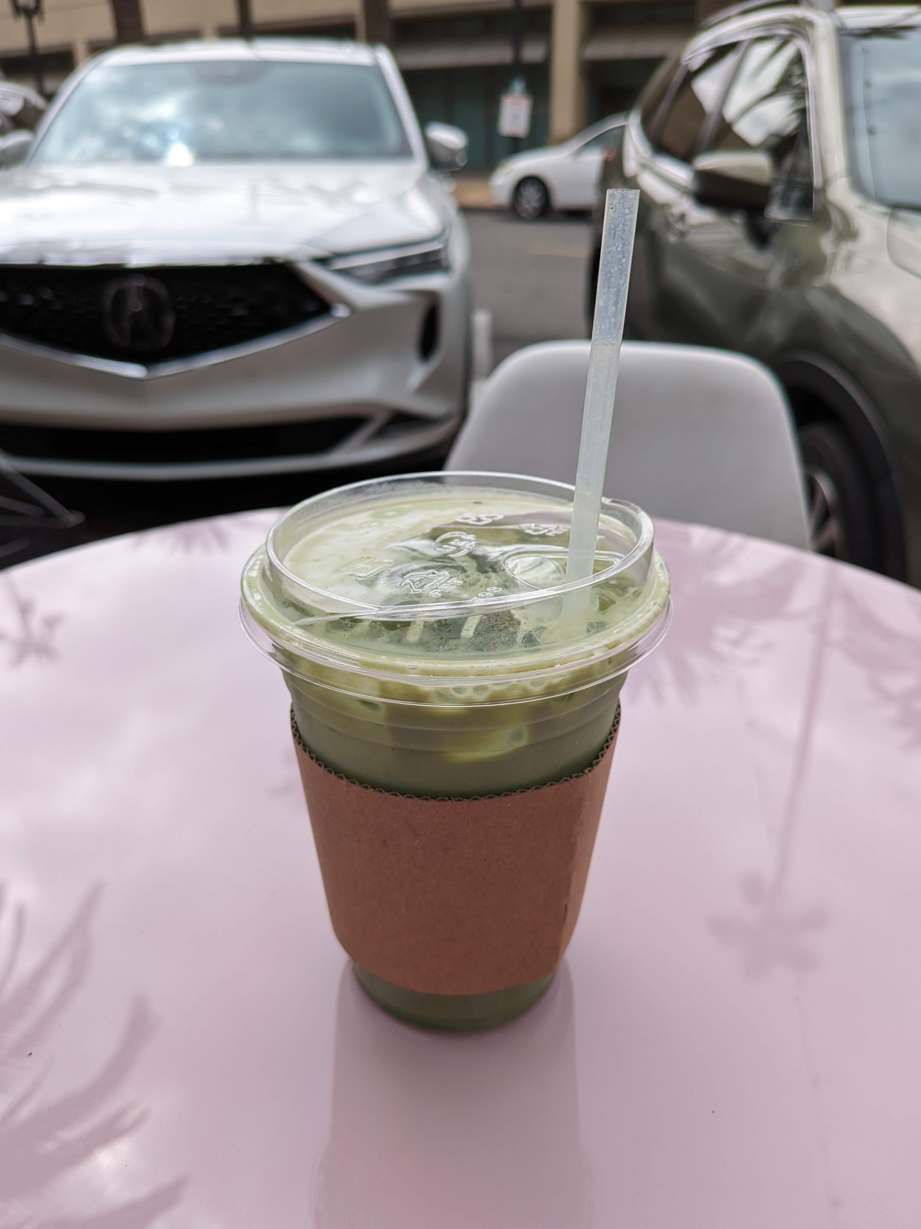 Iced matcha latte on a pink table taken with Google Pixel Fold.