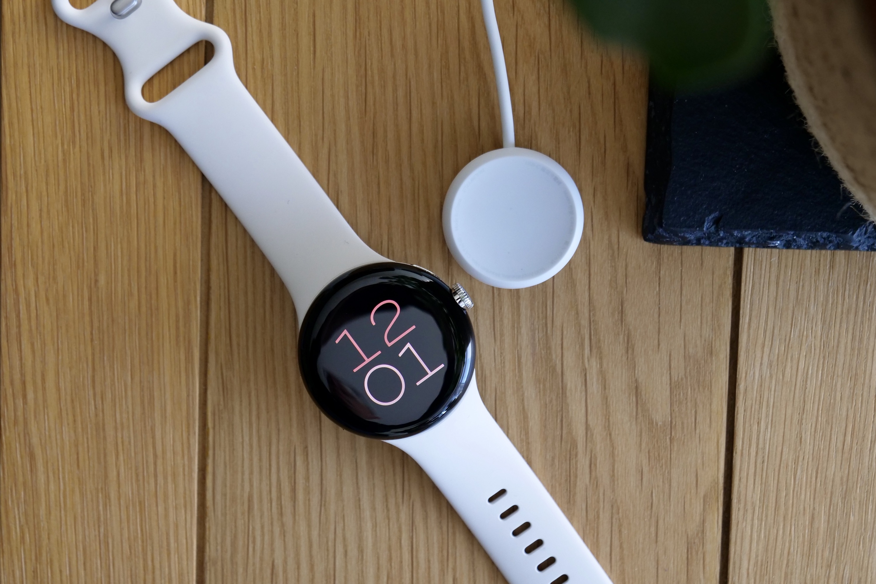 Google Pixel Watch with its charging puck.